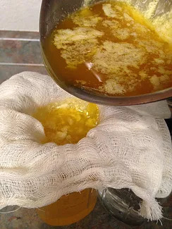 Pouring melted butter through cheesecloth to make ghee